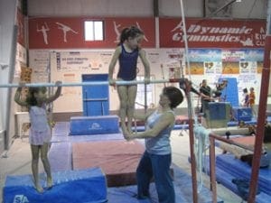 teodora training a gymnast on parallel-bars